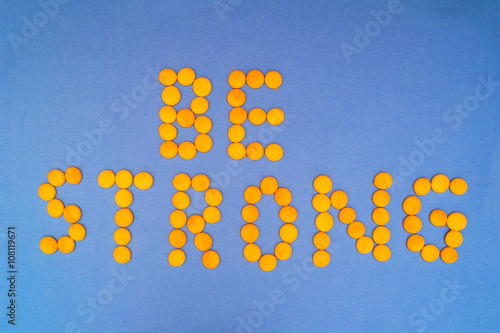 Be Strong, motivation quote. Letteras are mde of little yellow round on blue background photo