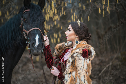 Princess with her horse in the woods