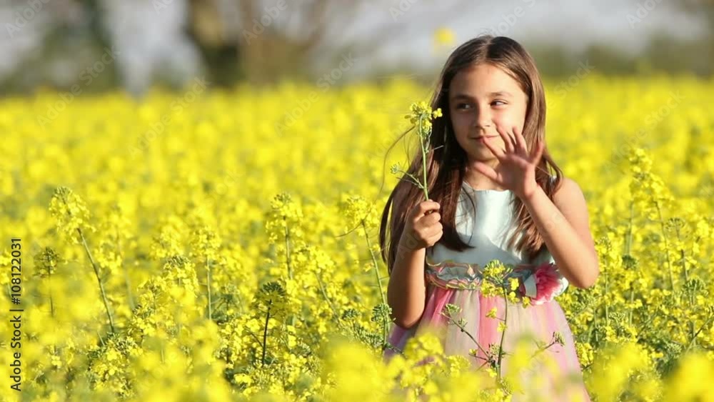 Happy Beauty young girl playing in yellow rape field in rural countryside. Portrait shot, Happy Freedom outdoors concept. Happy Beauty young girl playing in yellow rape field in rural countryside. Portrait shot, Happy Freedom outdoors concept.