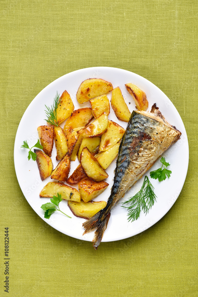 Roasted potato wedges and mackerel fish, top view