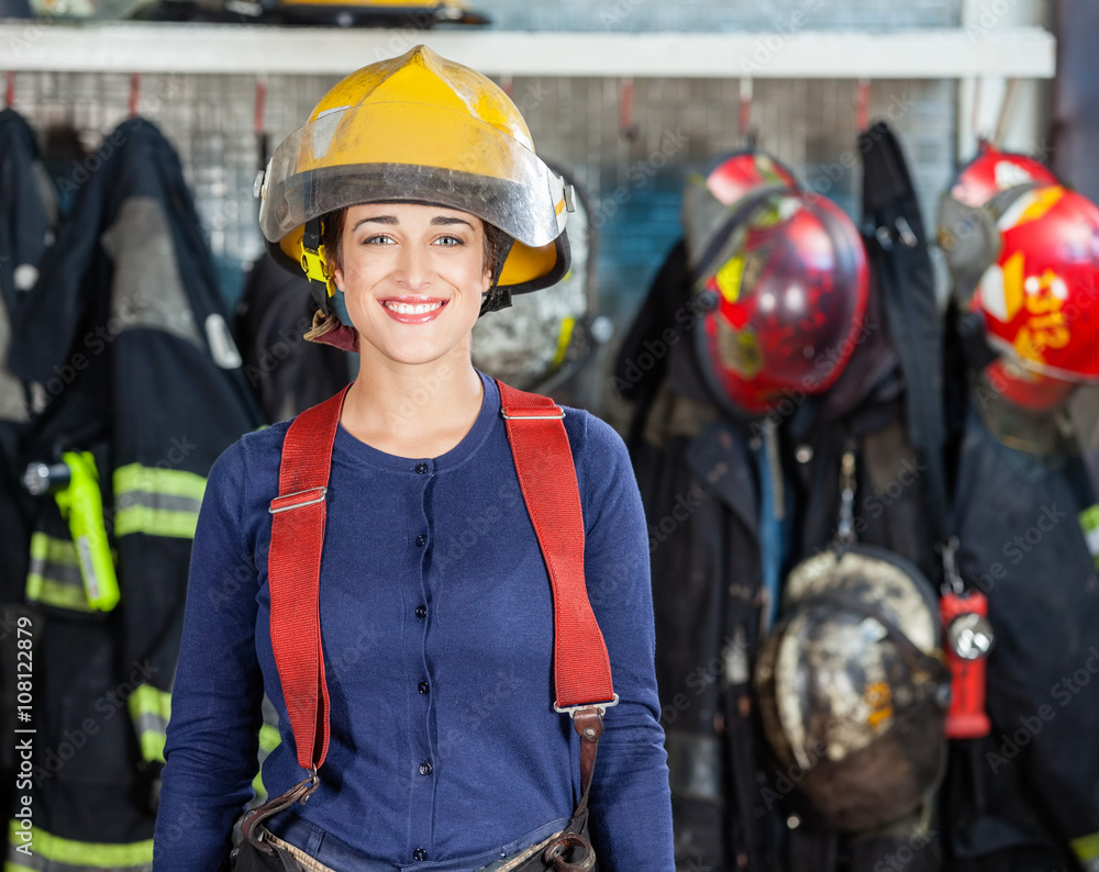 Naklejka premium Confident Firewoman Standing At Fire Station