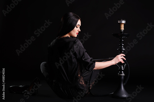 Young attractive girl in elegant dress and khalil mamoon hookah in studio.  photo