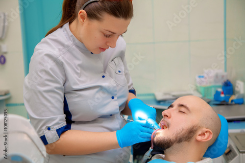 cute young boy checks his teeth in a dental office at the doctor