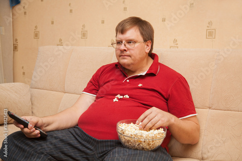 fat man eating popcorn