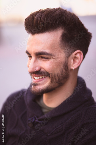 Portrait of a smiling young man in the city