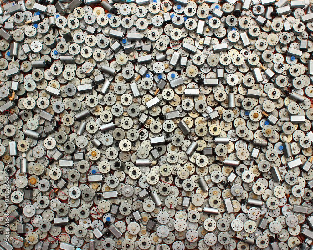 Many small used electric motors as background Many small used electric motors as background