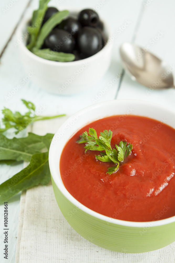 Colorful tomato soup on a white background, closeup Colorful tomato soup on a white background, closeup
