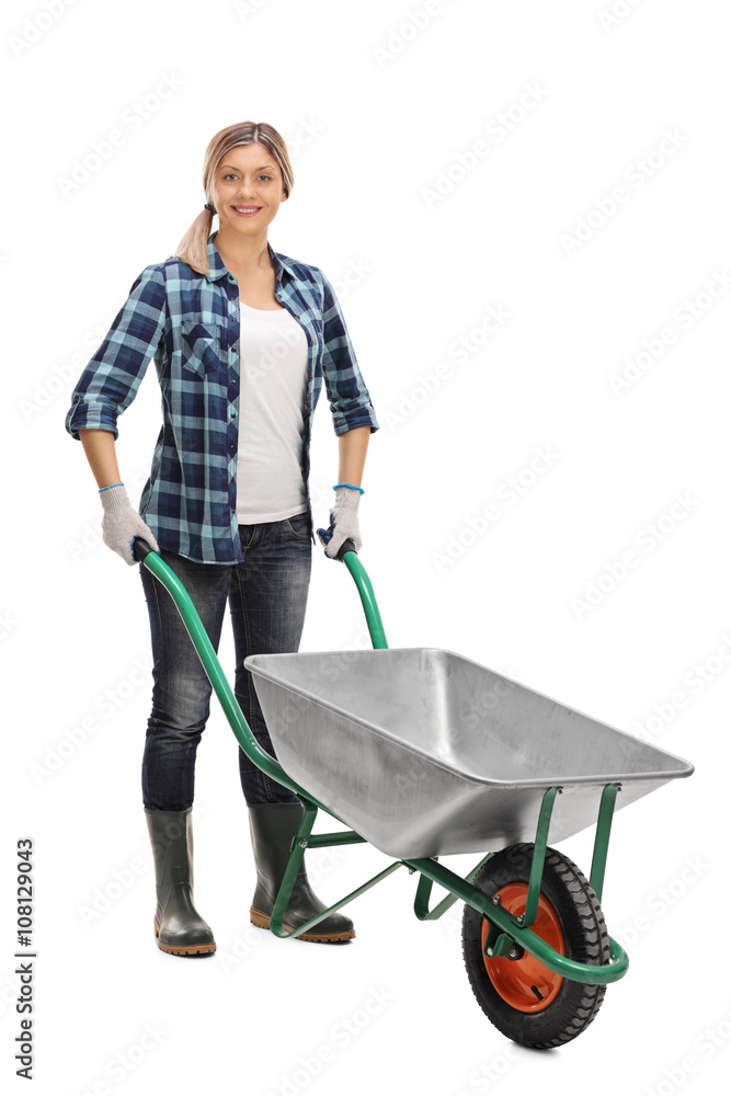 Woman posing with an empty wheelbarrow Woman posing with an empty wheelbarrow