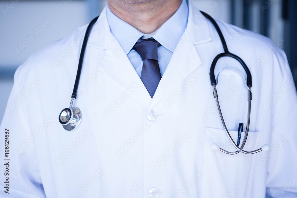 Male doctor in lab coat wearing stethoscope around neck Male doctor in lab coat wearing stethoscope around neck