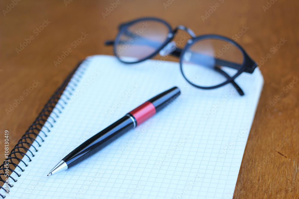 Pen and Notepad on the wooden desk Pen and Notepad on the wooden desk