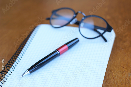 Pen and Notepad on the wooden desk