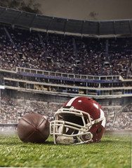The ball of american football players and helmet on stadium background