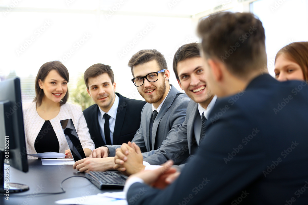 Group of business partners discussing ideas at meeting in office Group of business partners discussing ideas at meeting in office