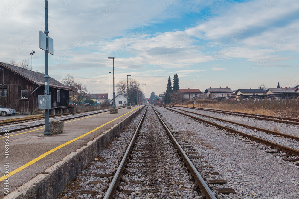 Small town railway station and cloudy blue sky on the background.