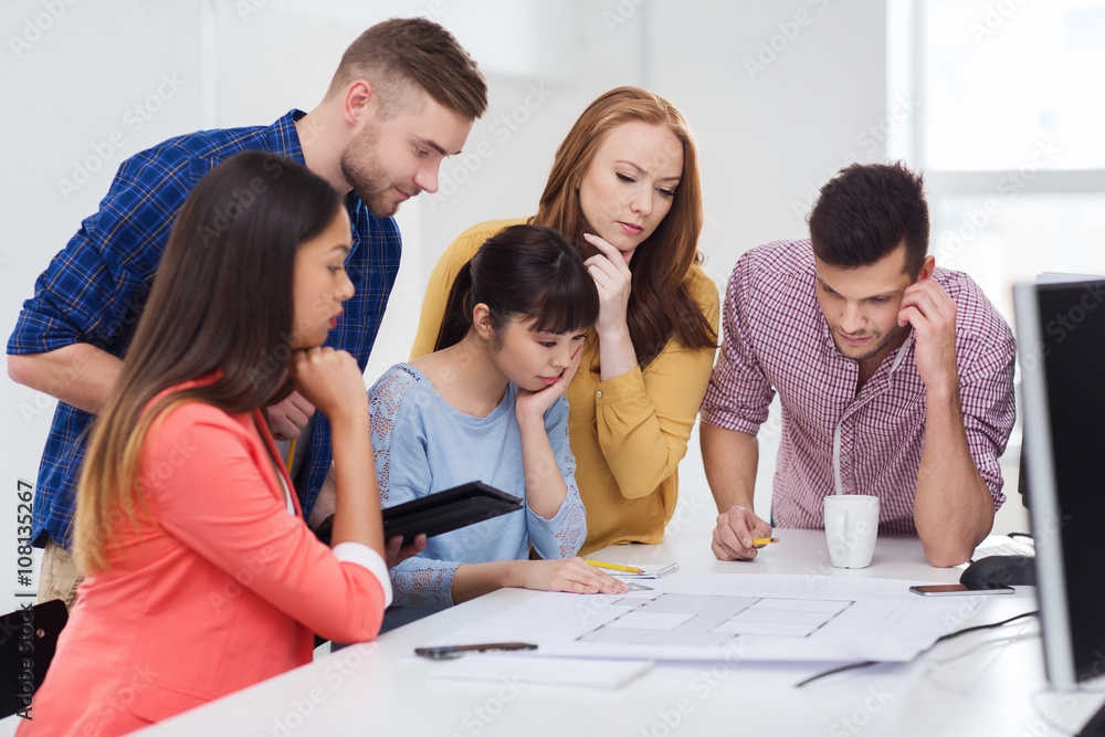 creative team with blueprint working at office creative team with blueprint working at office