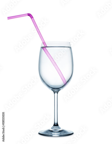 pink drinking straw in the wine glass full with water