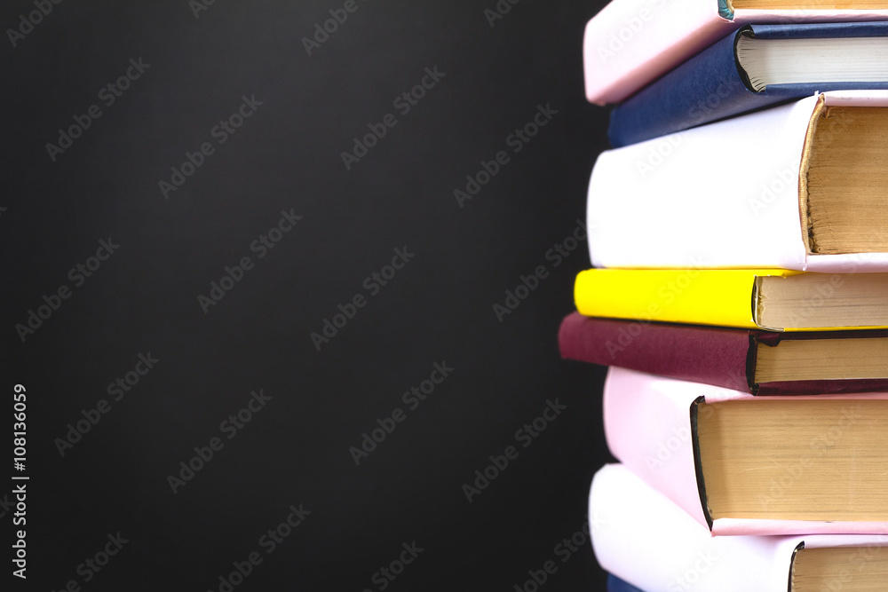Fototapeta premium Stack of books on black background