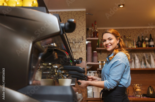 barista woman making coffee by machine at cafe