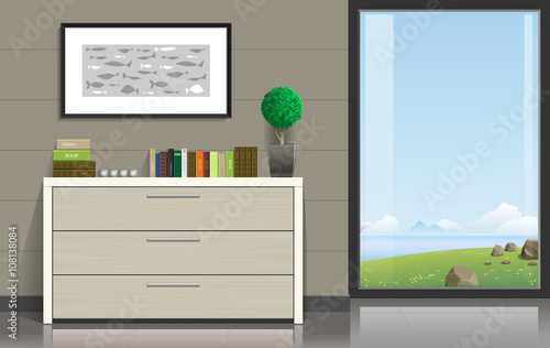 Interior room with a chest of drawers, pictures and a panoramic window overlooking the valley and the ocean