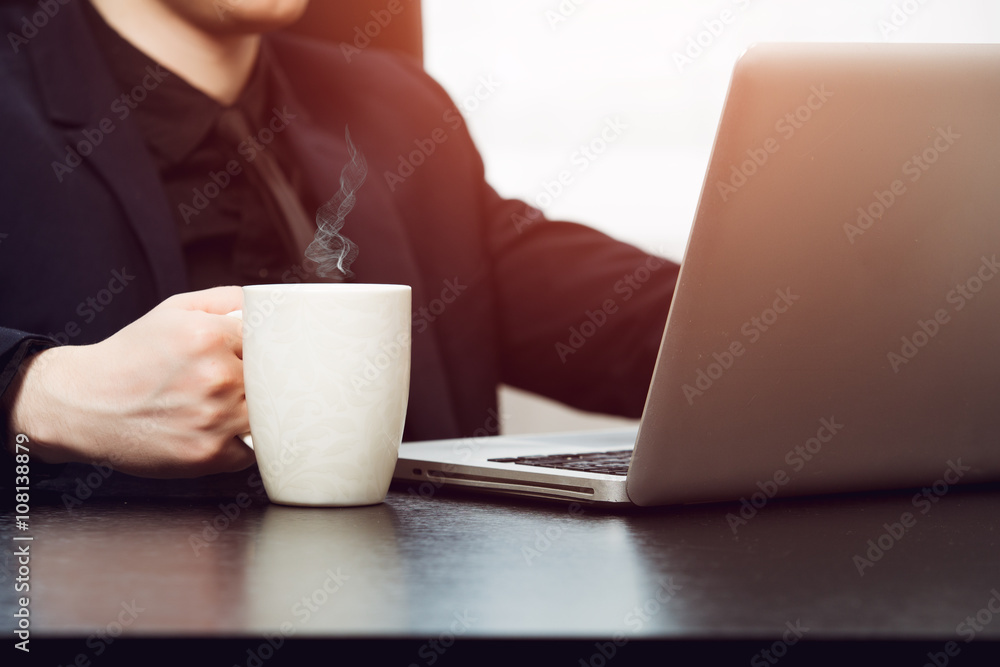 Closeup man in formal clothes holding cup of hot coffee Closeup man in formal clothes holding cup of hot coffee