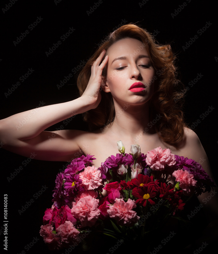 Beautiful woman with flowers on a black background.