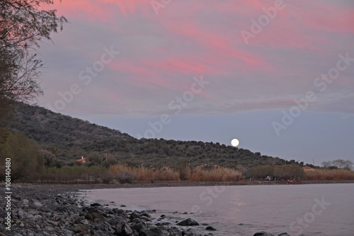 full moon in morning sunrise Lesvos Greece