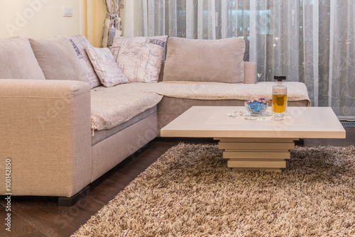 Low angle view of coffee table and white sofa photo