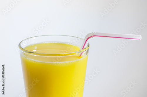 glass of orange juice with a straw