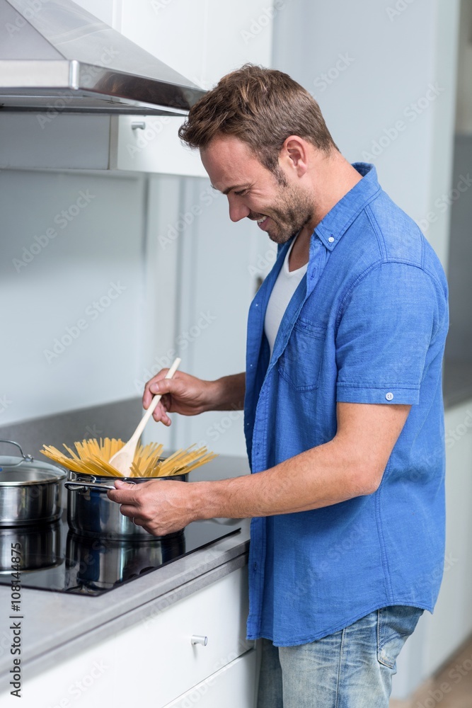 Young man cooking spaghetti Young man cooking spaghetti