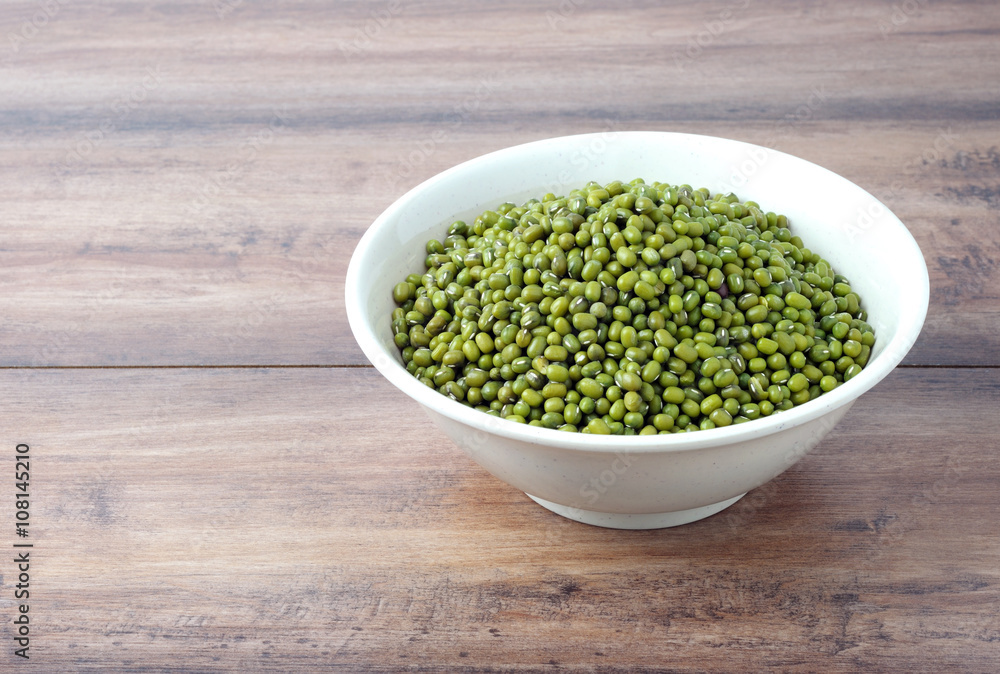 Mung beans in a bowl with wooden table Mung beans in a bowl with wooden table