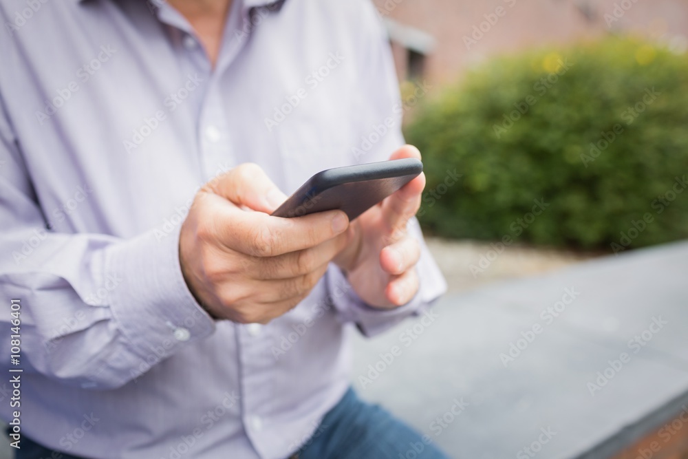 Mid section of a man using mobile phone Mid section of a man using mobile phone