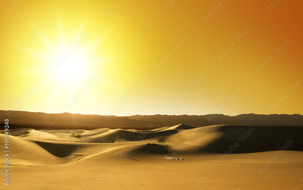 scenic view of sand dunes at sunset