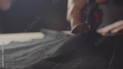 Dressmaker cutting fabric photo