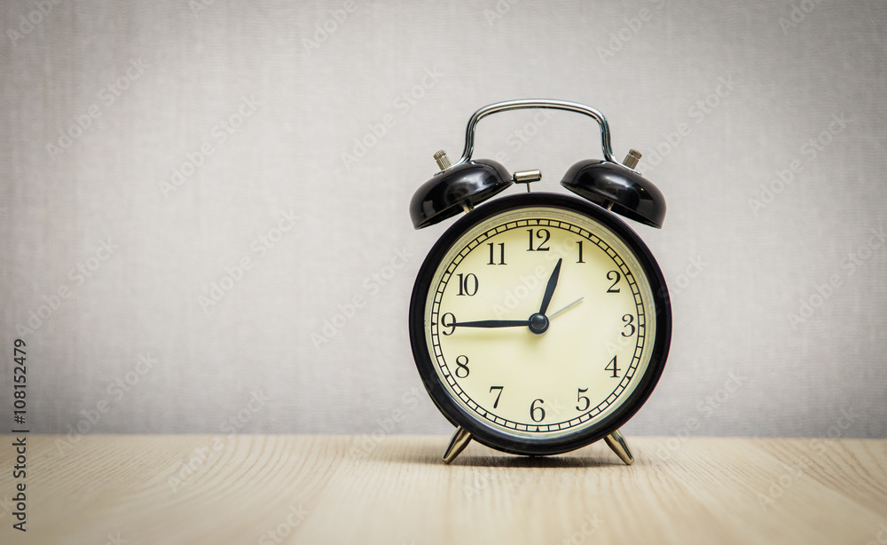 Black retro alarm clock on table wood, copy space. Black retro alarm clock on table wood, copy space.