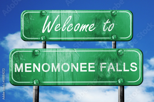 menomonee falls vintage green road sign with blue sky background photo