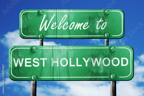 west hollywood vintage green road sign with blue sky background