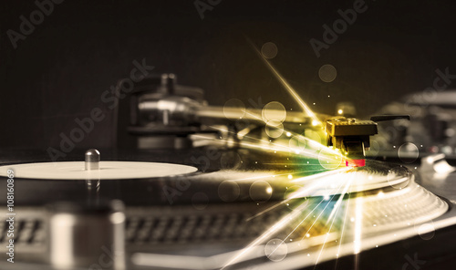Music player playing vinyl with glow lines comming from the need