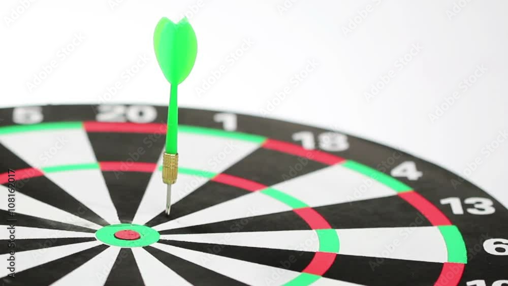 Six darts in red and green color hitting the dartboard, low angle shot, white background Six darts in red and green color hitting the dartboard, low angle shot, white background