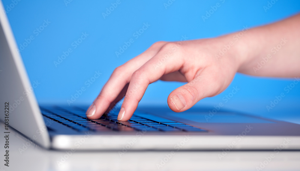 Close up of hand pressing keyboard buttons Close up of hand pressing keyboard buttons