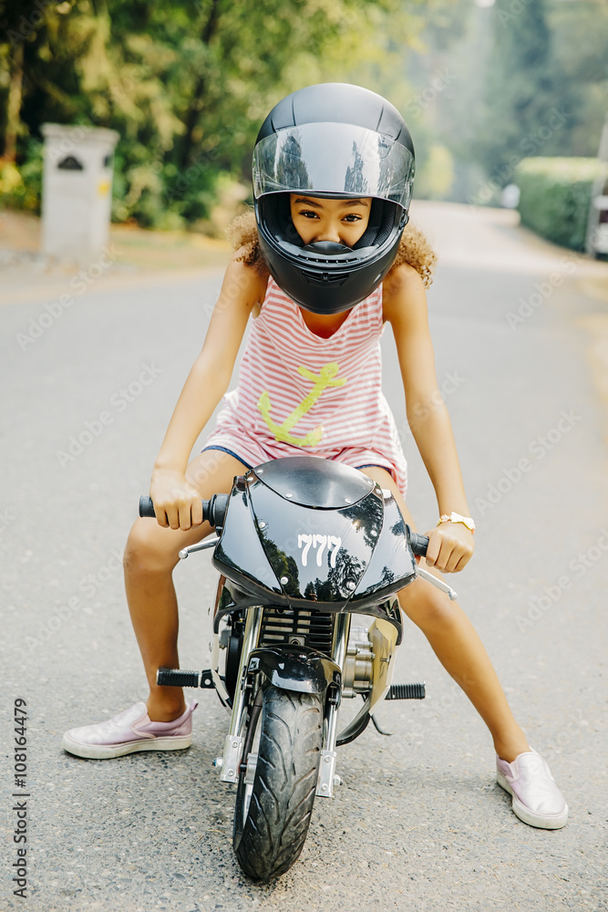 Portrait of teen girl on miniature motorcycle Stock Photo Adobe