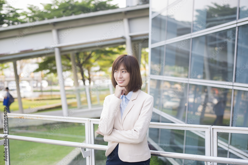 Fototapeta premium Attractive asian business woman smiling outside office