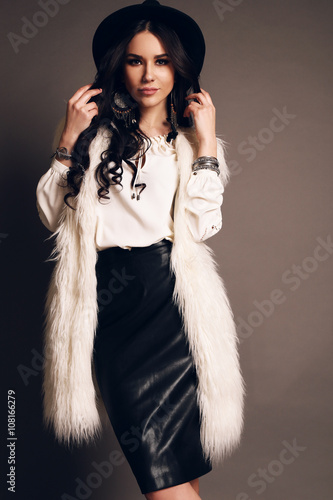 fashion studio photo of gorgeous sensual woman with long dark hair wears elegant clothes and hat