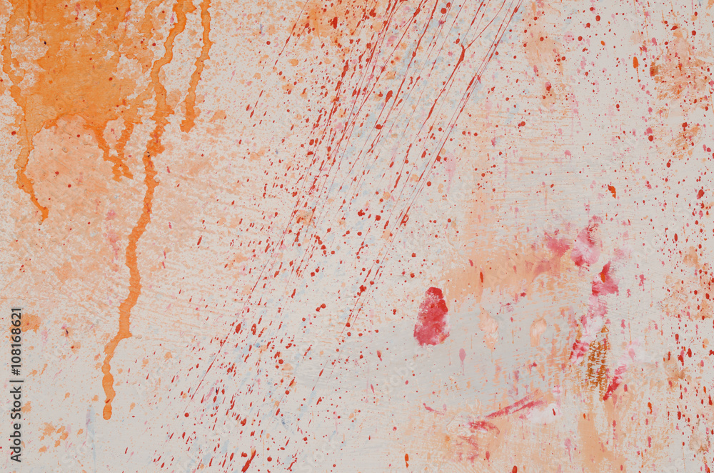 Red and blue paint splashes on grunge wall. Abstract hand painted backdrop for your design