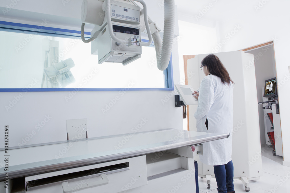 Hispanic doctor using x-ray in hospital Hispanic doctor using x-ray in hospital