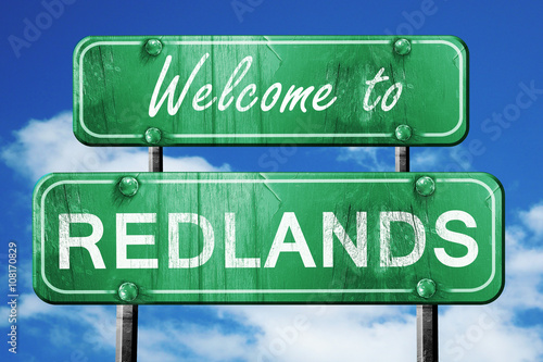 redlands vintage green road sign with blue sky background photo