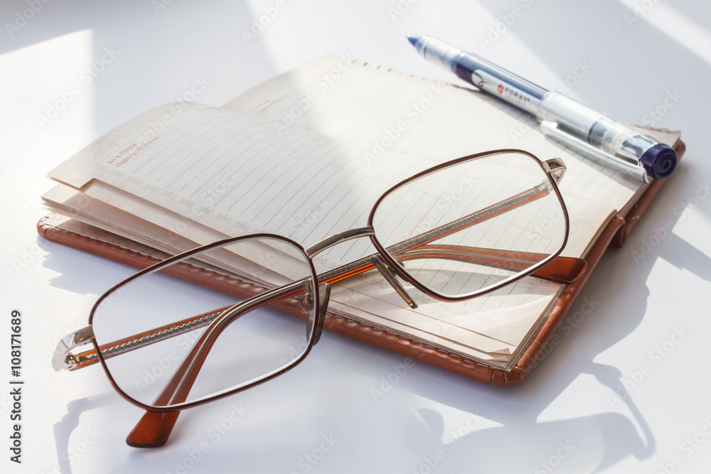 Notepad with glasses and pencil Notepad with glasses and pencil