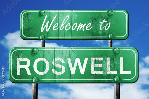 roswell vintage green road sign with blue sky background photo