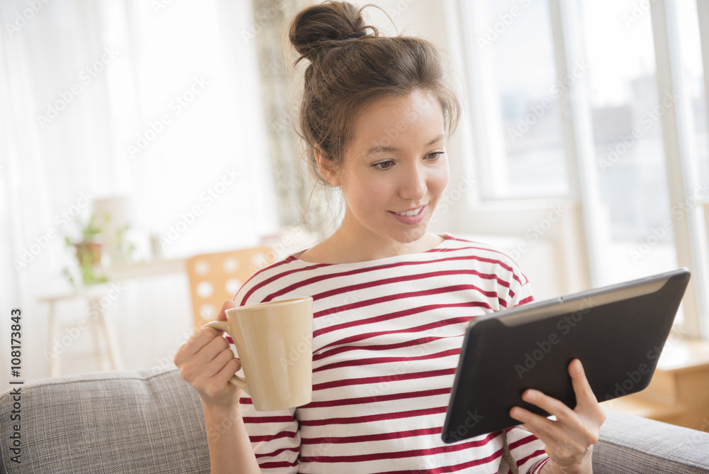 Mixed race woman using digital tablet Mixed race woman using digital tablet
