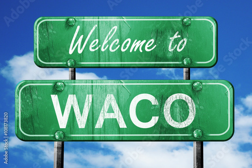 waco vintage green road sign with blue sky background photo