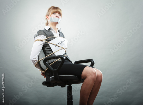 Businesswoman bound by contract with taped mouth.